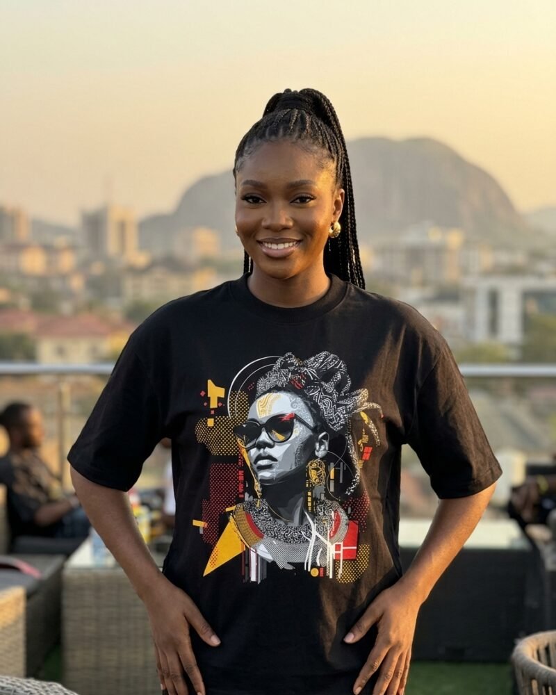 Stylish Nigerian woman in Maitama Abuja wearing the Shakara Drip Cat-Eye Circuit oversized black graphic tee